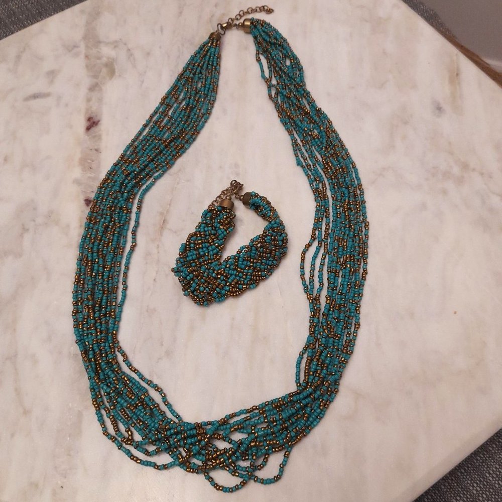 Turquoise and gold multi layer beaded necklace and bracelet.